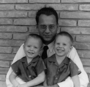 Dad holding his 2 sons, late 50s